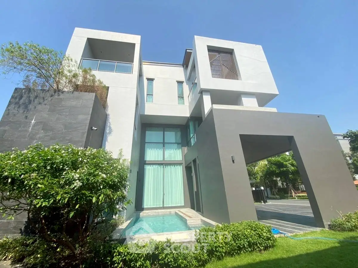 Modern luxury villa with sleek architecture and private pool in lush green setting.