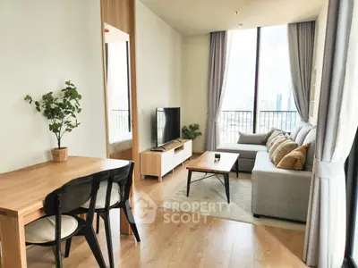 Modern living room with city view, stylish furniture, and natural light