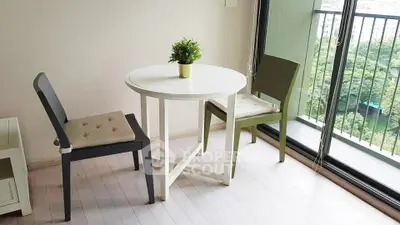 Charming apartment balcony with cozy seating and lush green view