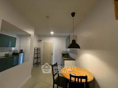Cozy kitchen with modern open layout and dining area in a stylish apartment.
