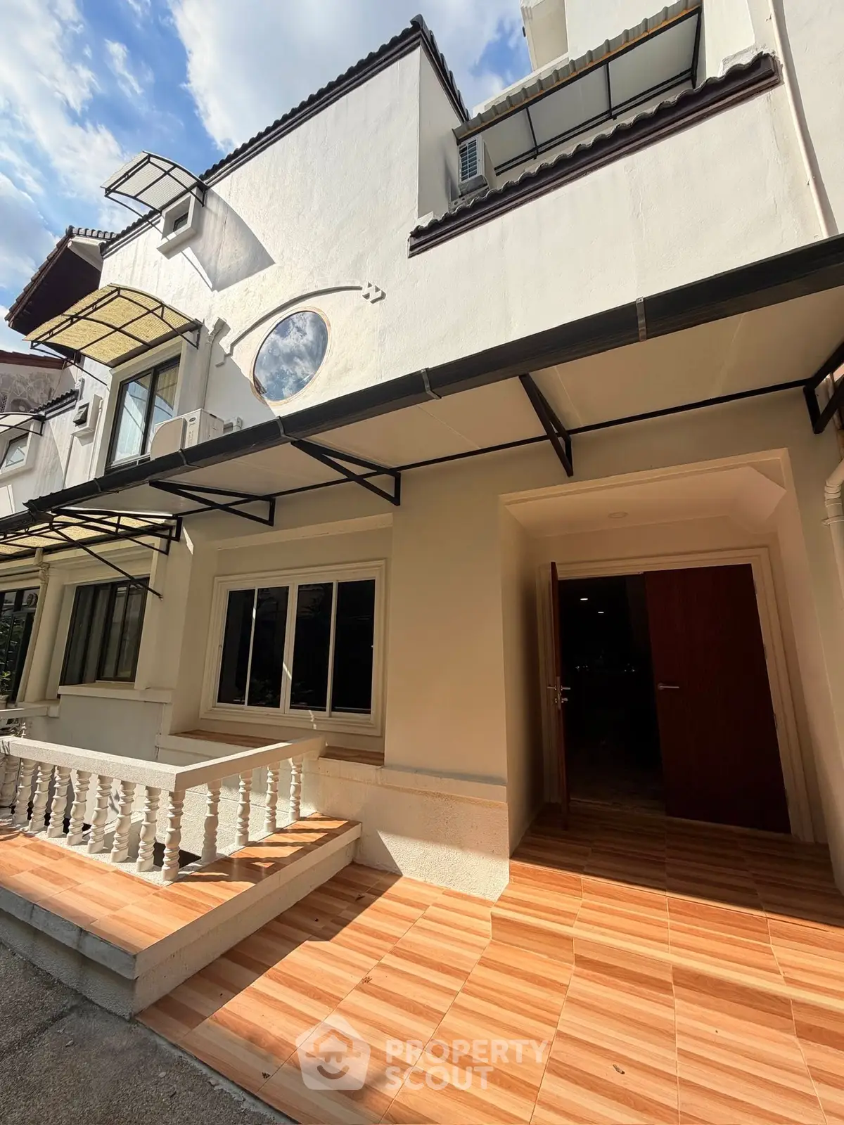 Charming townhouse exterior with tiled entrance and classic architectural details.