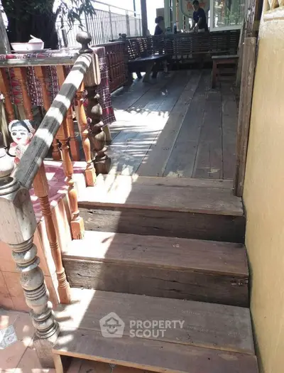 Charming rustic wooden deck with cozy seating area and decorative elements.