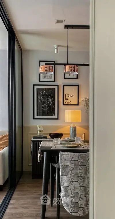 Stylish dining area with modern decor and elegant lighting in a cozy apartment setting.