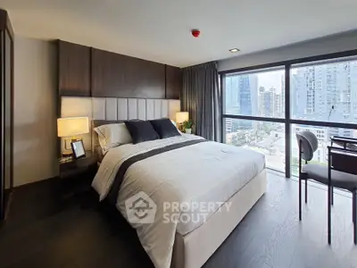 Luxurious bedroom with city view, modern decor, and ample natural light in high-rise apartment.