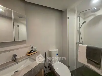 Modern bathroom with glass shower and sleek fixtures