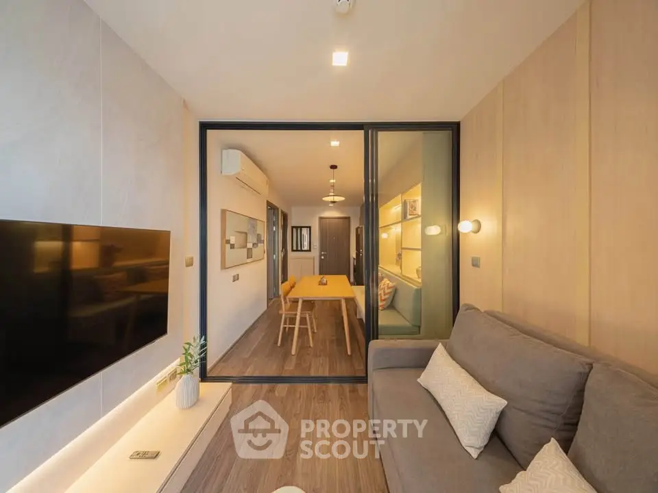 Modern living room with stylish decor and open layout leading to dining area.