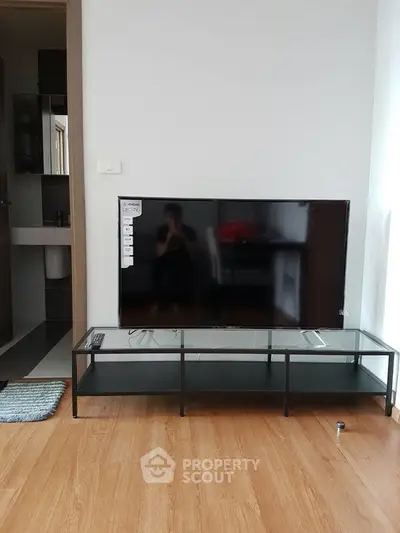 Modern living room with sleek TV stand and hardwood flooring