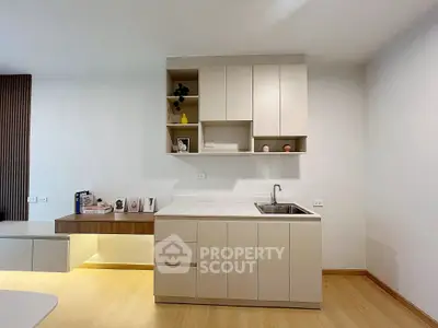 Modern minimalist kitchen with sleek cabinetry and integrated sink