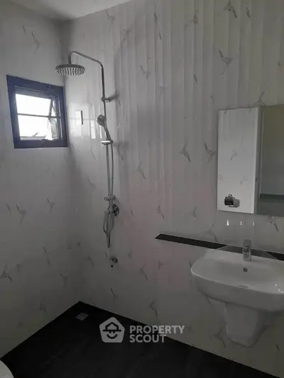 Modern bathroom with sleek shower and minimalist sink design