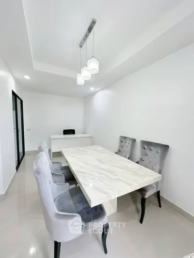 Elegant modern study room with marble table and plush chairs in minimalist design.