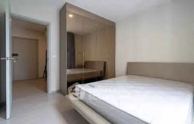 Modern bedroom with sleek mirrored wardrobe and minimalist design