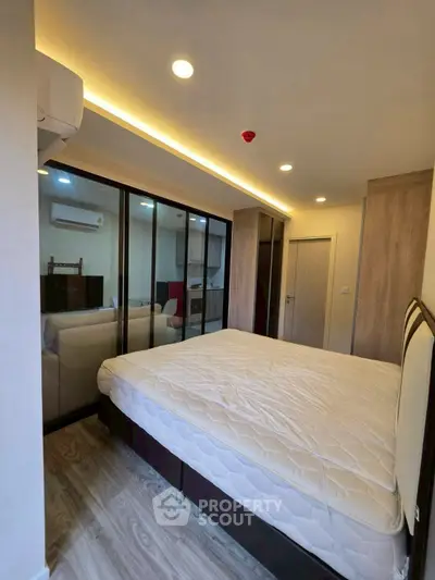Modern bedroom with glass partition and cozy lighting in a stylish apartment