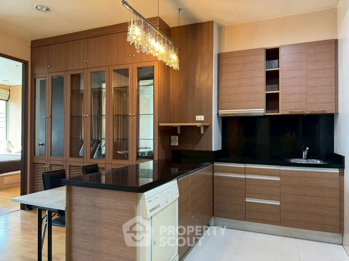Modern kitchen with sleek wooden cabinets and elegant lighting