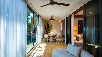 Luxurious living room with elegant decor and natural light, featuring a cozy seating area and stylish dining space.