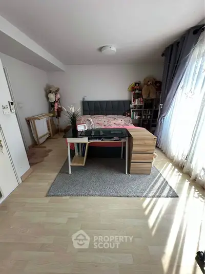 Spacious bedroom with modern decor and ample natural light