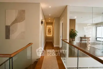 Elegant hallway with modern decor and glass railing in luxury home