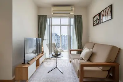 Modern living room with balcony view, stylish furniture, and natural light.