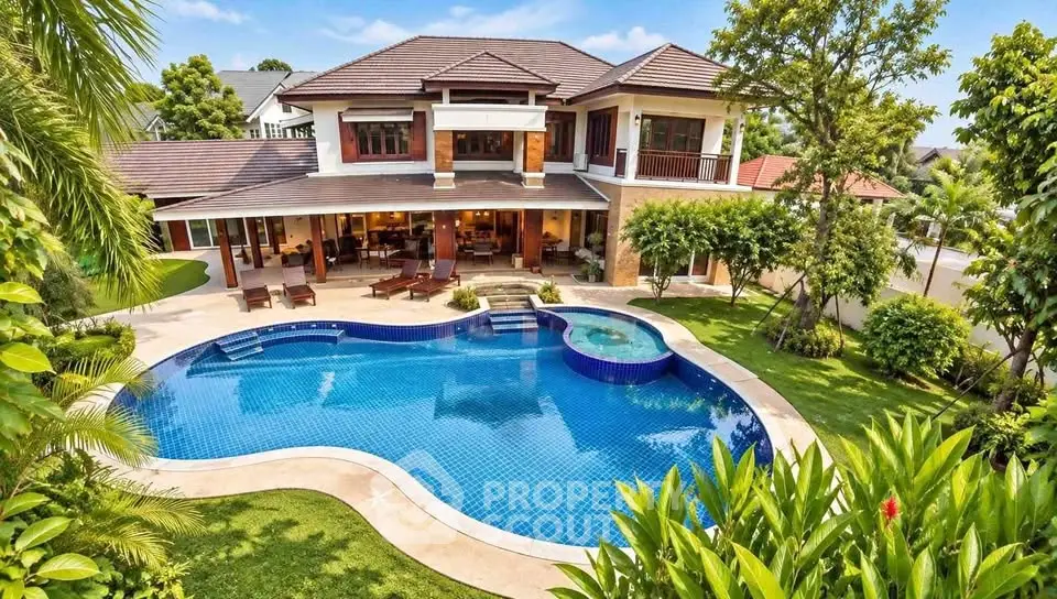 Luxurious villa with stunning pool and lush garden in tropical setting.