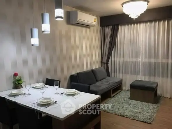 Modern living room with elegant dining area and stylish lighting in a cozy apartment.