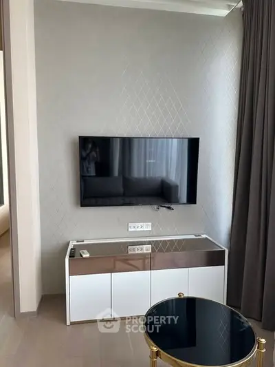 Modern living room with wall-mounted TV and stylish furniture