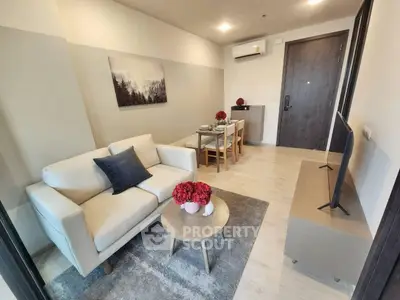 Modern living room with cozy sofa and dining area in stylish apartment.