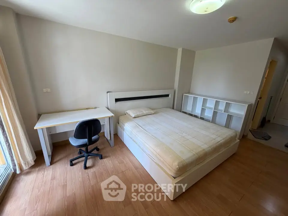 Spacious bedroom with modern furniture and natural light, perfect for comfortable living.