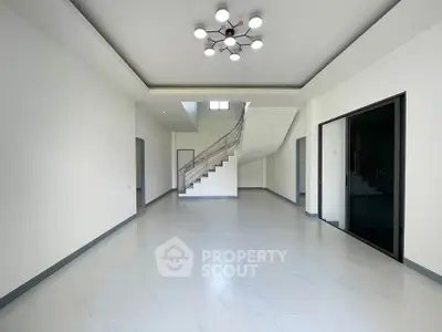 Spacious modern interior with elegant staircase and stylish lighting