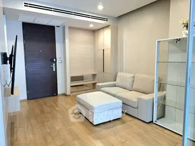 Modern living room with cozy sofa and wooden flooring in a stylish apartment.