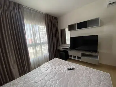 Modern bedroom with large window, stylish curtains, and sleek TV setup.