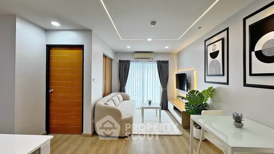 Modern living room with stylish decor, cozy sofa, and wall-mounted TV in a bright apartment.