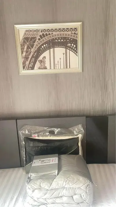 Stylish bedroom with modern decor and framed artwork above bed.