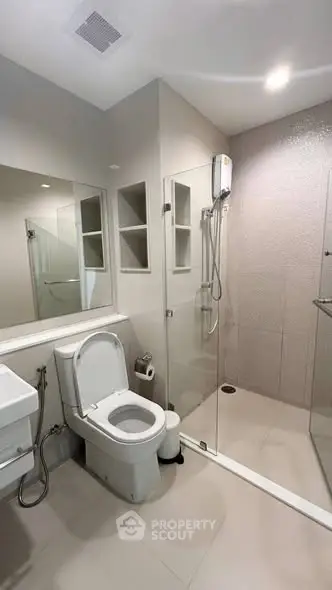 Modern bathroom with glass shower and sleek fixtures