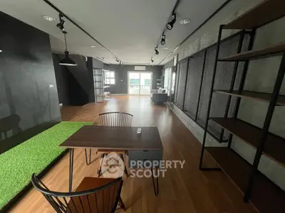 Spacious modern living room with wooden flooring and stylish furniture