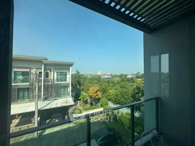 Spacious balcony with scenic view of suburban neighborhood and lush greenery.