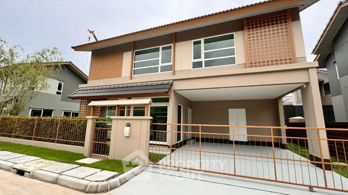 Modern two-story house with spacious driveway and contemporary design.