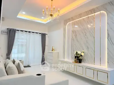 Luxurious living room with elegant chandelier and marble accent wall