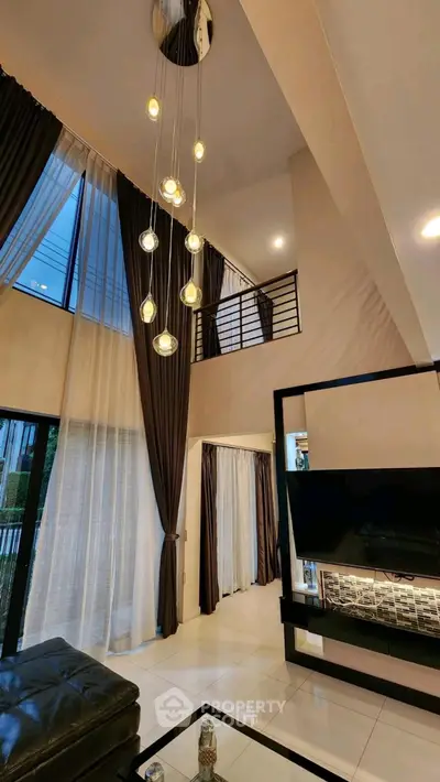 Luxurious modern living room with high ceilings and elegant lighting in a stylish home.