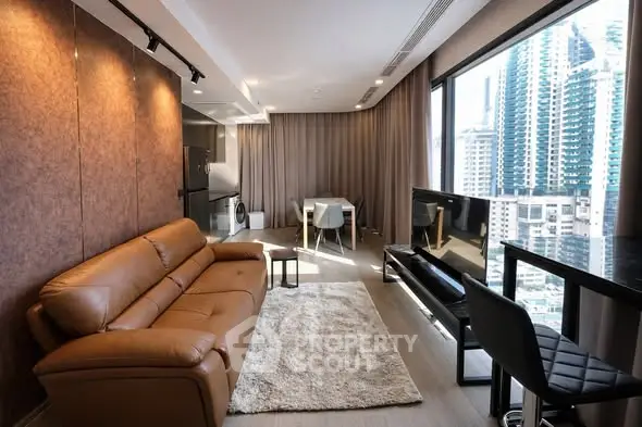 Modern living room with city view, leather sofa, and sleek decor in high-rise apartment.