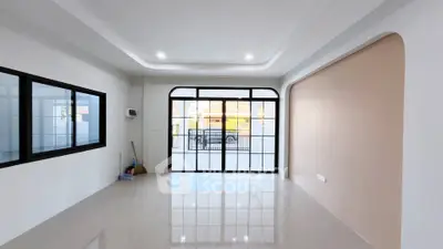 Spacious modern living room with large windows and glossy floor tiles