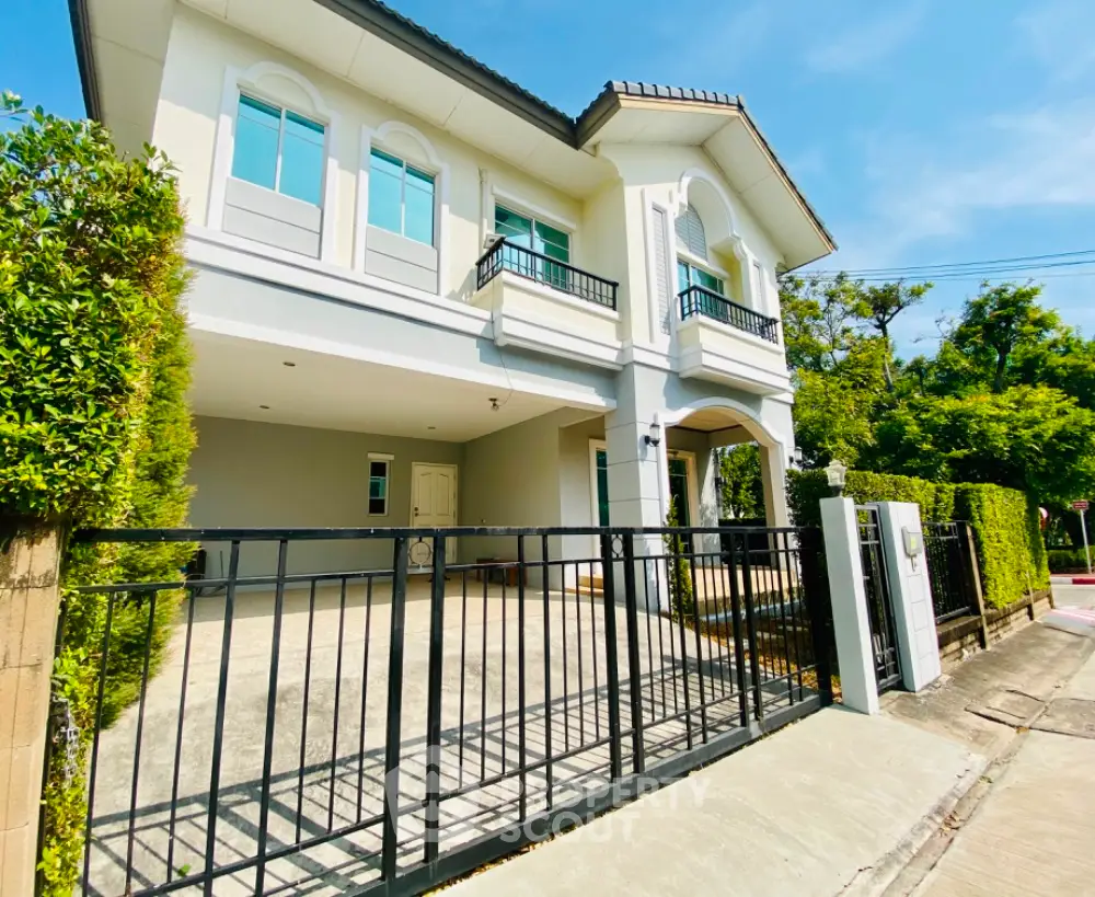 Stunning two-story house with modern facade and lush greenery in a serene neighborhood.