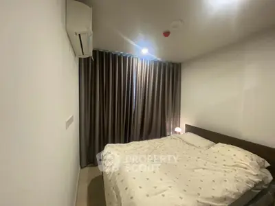 Cozy bedroom with air conditioning and elegant curtains, perfect for restful nights.