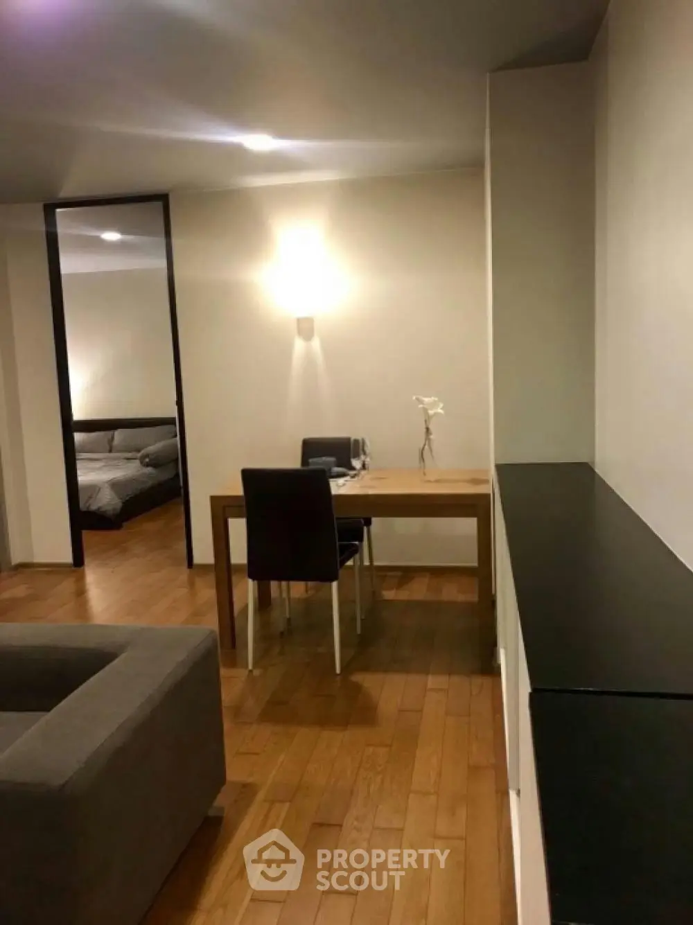 Modern apartment interior with wooden flooring and cozy dining area.