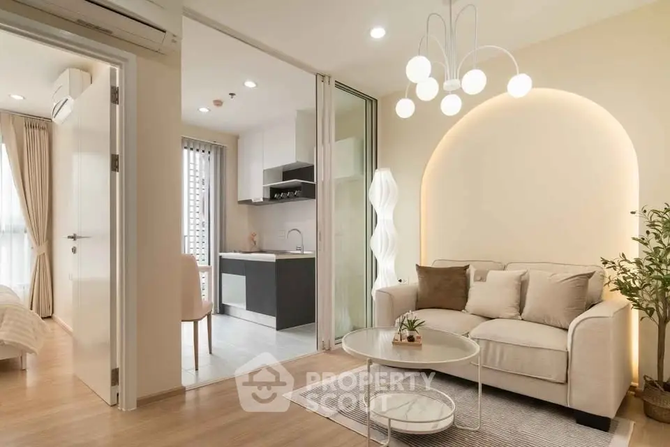 Modern open-concept living room with stylish lighting and cozy seating area.