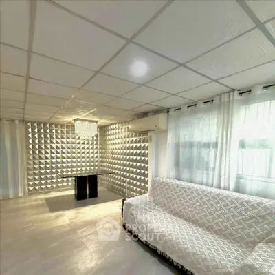 Modern living room with unique wall design and elegant sofa