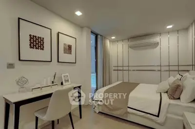 Modern bedroom with stylish decor and workspace, featuring elegant lighting and a cozy atmosphere.