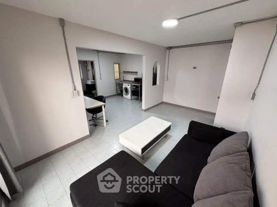 Spacious living room with modern furniture and open kitchen layout