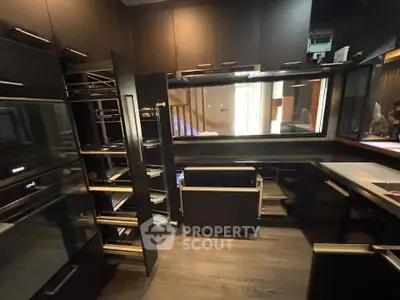 Modern kitchen with sleek black cabinetry and open layout design