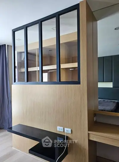 Modern bedroom with stylish partition and sleek black shelf