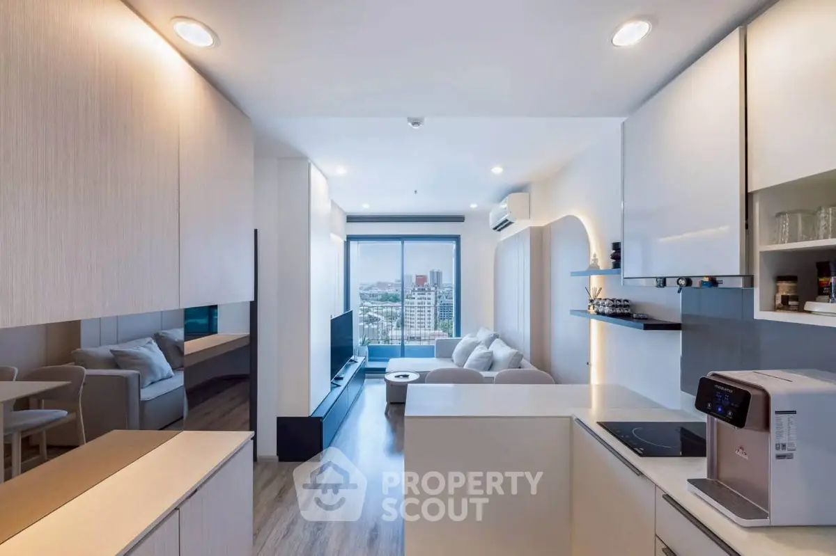 Modern open-layout living room with city view, sleek kitchen, and cozy seating area.