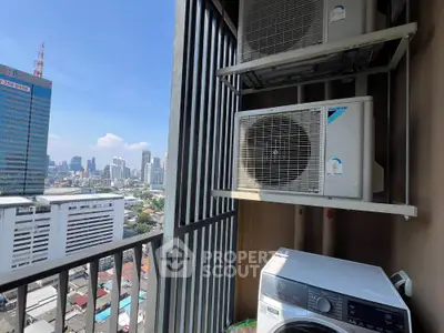 High-rise apartment balcony with city view and air conditioning units.